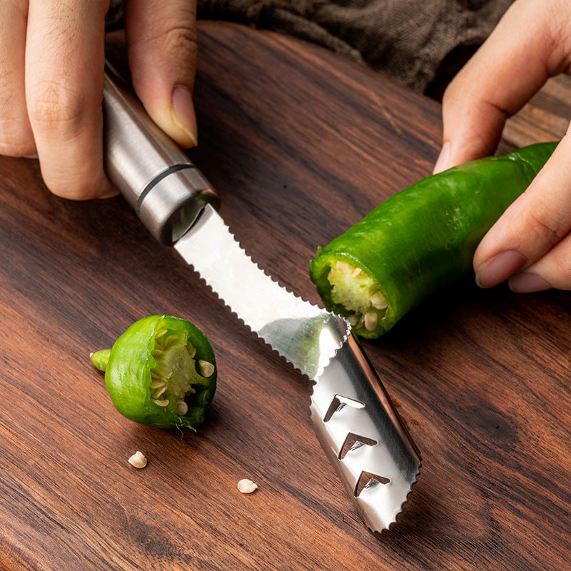 Person using a jalapeño pepper slicer on a wooden cutting board